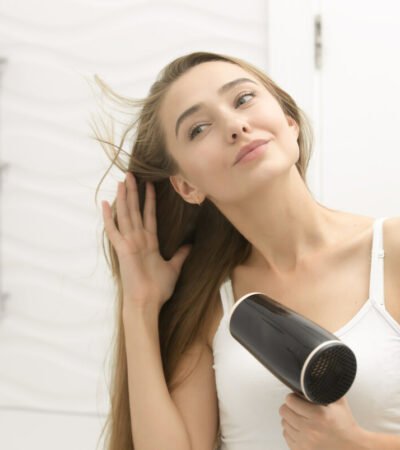 teen girl drying hair
